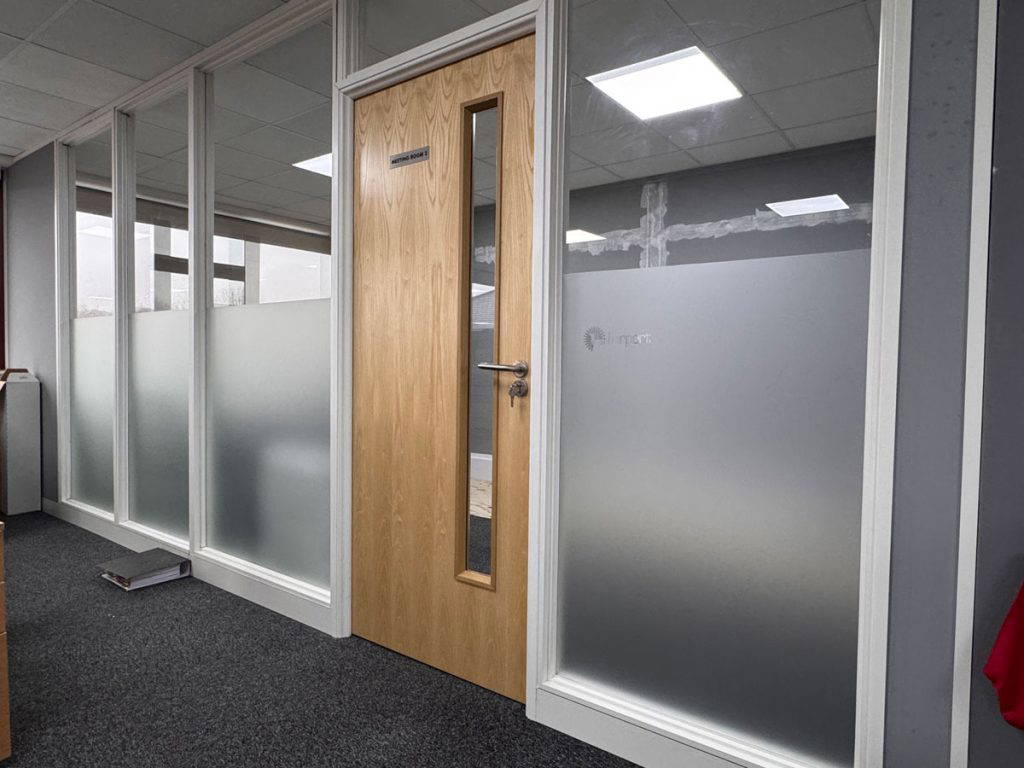 office with four frosted glass windows and oak door
